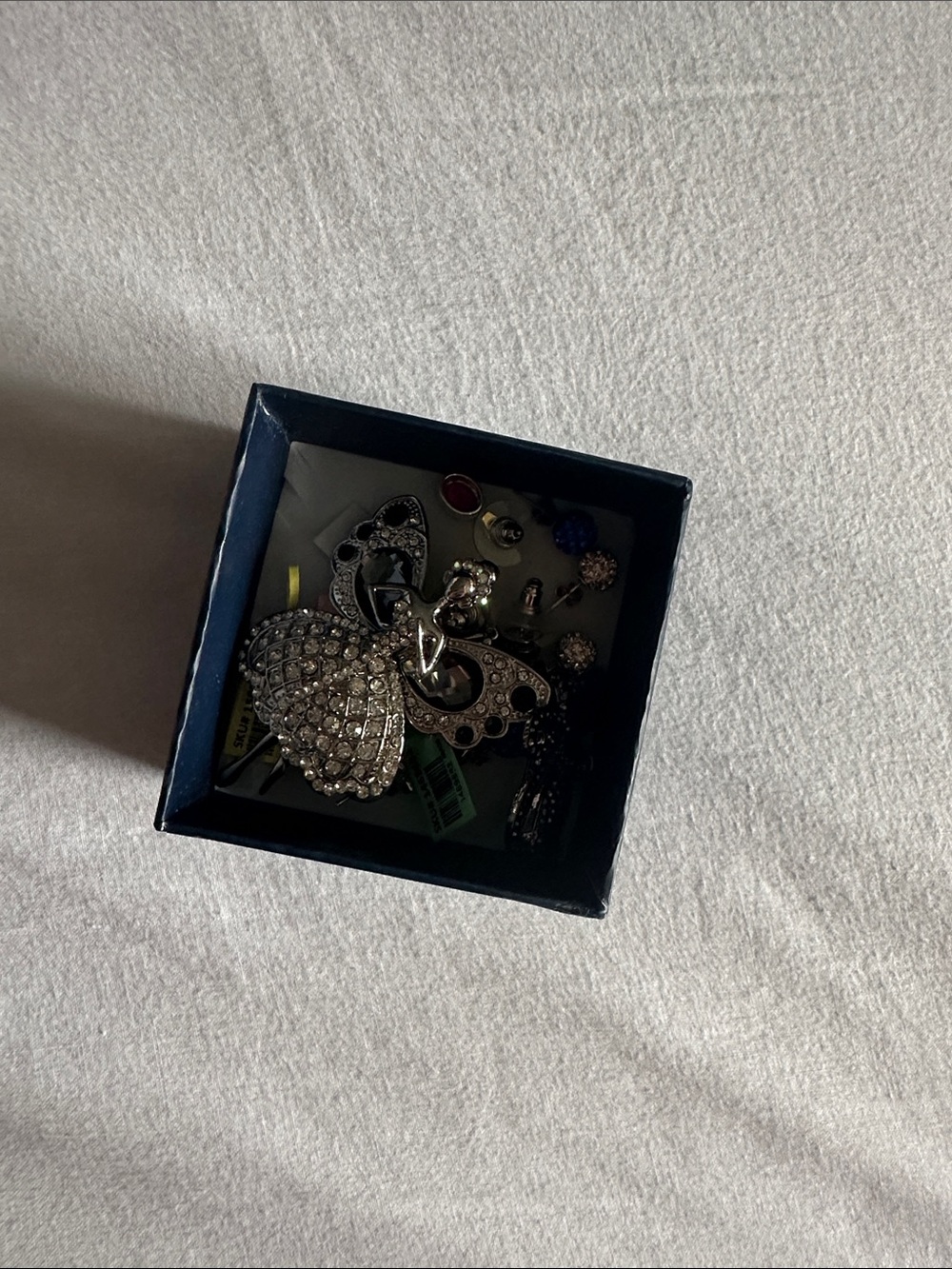 two pins and assortment of women’s earrings